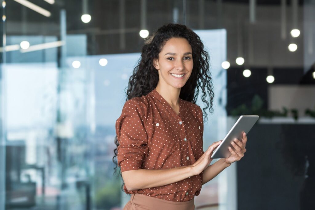 smiling woman using tablet at office